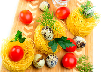 Pasta nests with cherry tomatoes and quail eggs.