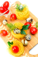 Pasta nests with cherry tomatoes and quail eggs.