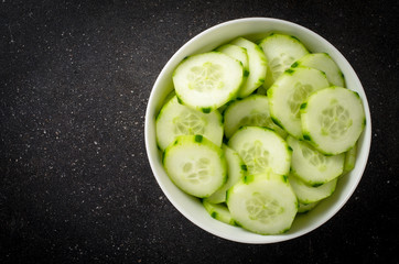 Cucumber slices in white bowl