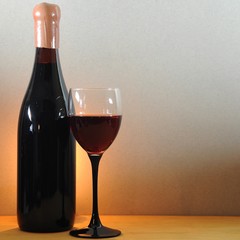 Wine glass and old bottle on a wooden table