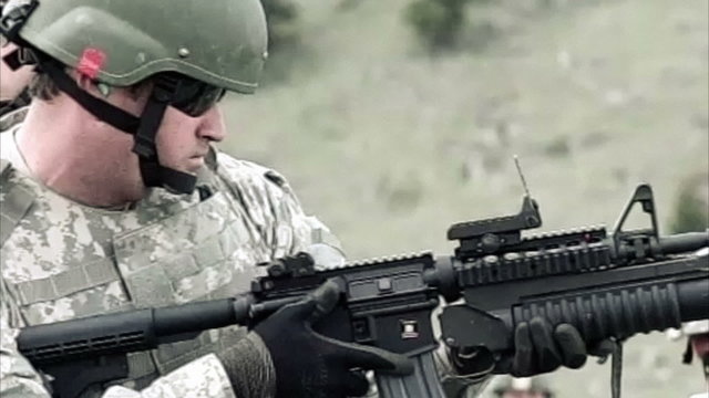 Slow motion clip of soldier learning to use a 40 mm grenade launcher attached to M4 assault rifle.