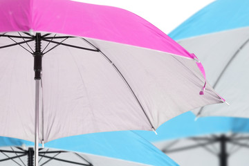 Pink umbrella / Close up pink umbrella on blue umbrella background.