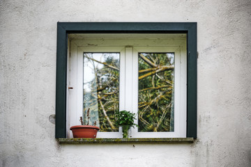 Fototapeta na wymiar white window in a rustic wall