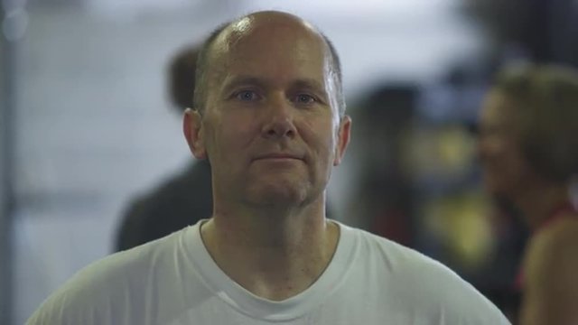 Static shot of a balding middle-aged man