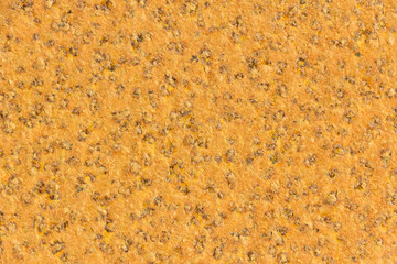 Light brown to orange rust-covered steel sheet texture or background.