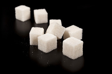 sugar cubes isolated on black background