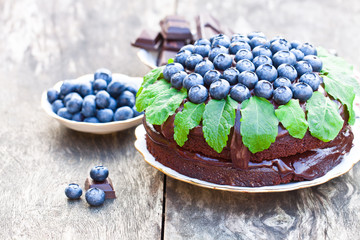 Chocolate  cake with chocolate cream and fresh blueberries and m