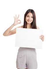 Fototapeta premium Beautiful young Asian woman show OK with blank sign
