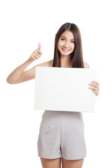 Fototapeta premium Beautiful young Asian woman thumbs up with blank sign