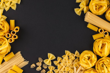 Different types of pasta on the black background