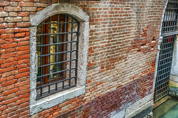 old wndow in a brick wall in Venice
