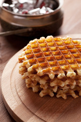 Belgian waffles on wooden table