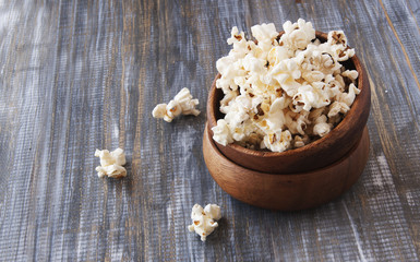  bowl of popcorn on a brown wooden table