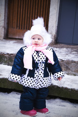 Small very cute girl in a winter suit