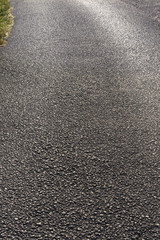 road in backlight/ gray structure of asphalt road in backlight