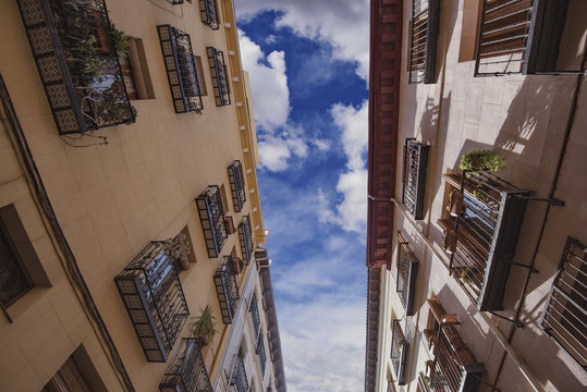 Residential buildings on a narrow street in Madrid, Spain.