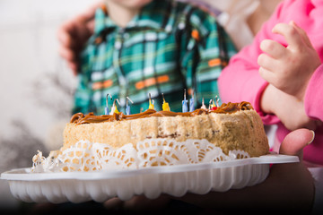 happy family with two kids  with cake at home