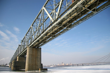 Railway bridge over the River frozen winter. Photographed from b
