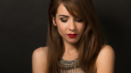 Beautiful lady posing with necklace in studio