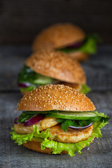 Three homemade hamburgers with fresh vegetables