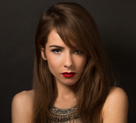 Fototapeta premium Beautiful lady posing with necklace in studio