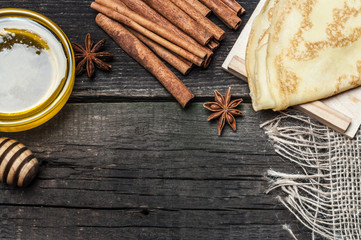Pancakes on a plate, tea and spices
