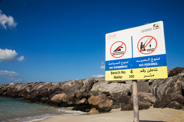 Stand with the rules of conduct on the beach