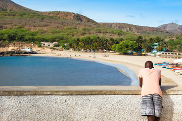 African boy watching to Tarrafal beach in Santiago island in Cap