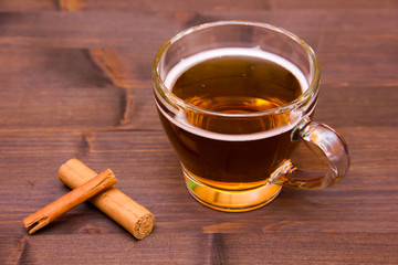 Herbal tea with cinnamon on wooden table