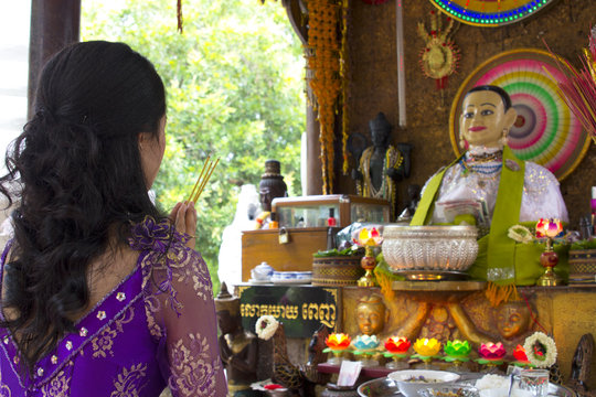 Asian girl praying in temple