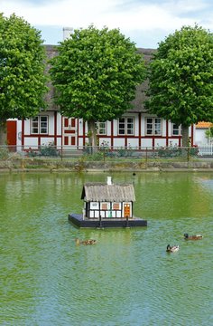 Traditional, half-timbered cottage and village pond with ducks  Nordby, Samsoe ( Sams&oslash; ), Denmark