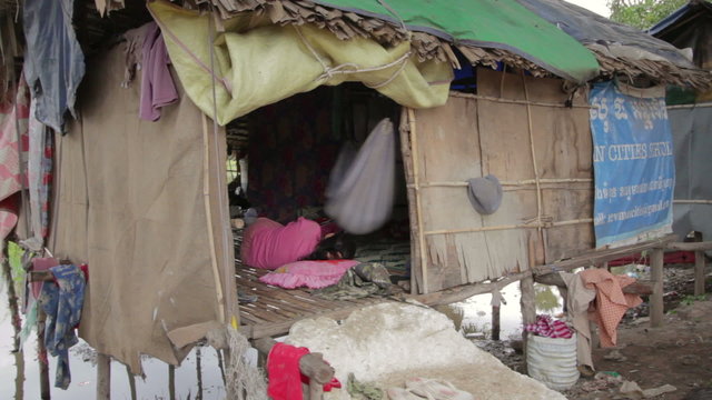 Cambodian family in slum, inside shack