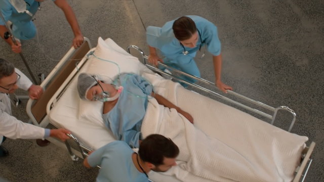 Medical team carrying a patient to intensive care unit