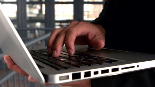 Businessmans hands typing on laptop keyboard