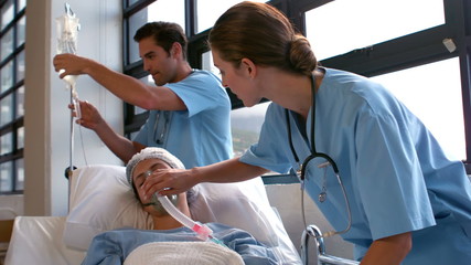 Medical team carrying a patient to intensive care unit