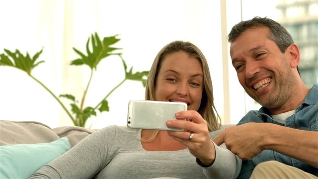 Happy future parents taking selfie