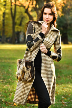 Attracttive young model posing at Central Park New York location for fall fashion photo shoot.