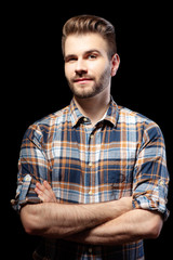 Young man keeping arms crossed.