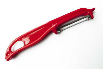 red potato peeler on white background