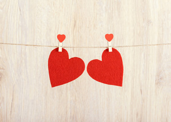 Two red hearts hung on the rope