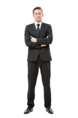 Young businessman in suit and tie keeping arms crossed