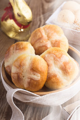 Homemade Easter hot cross buns in wooden bowl