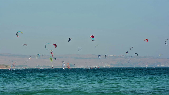 Tarifa, Spain. July 2015. Crow of windsurfers and kitesurfers