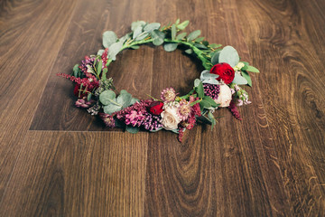 Beautiful wedding red rose flower crown on wooden background