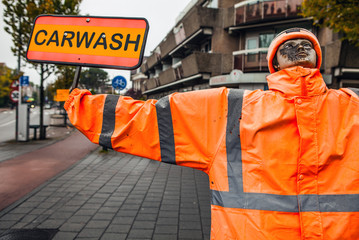Dummy in orange jacket with burned face.