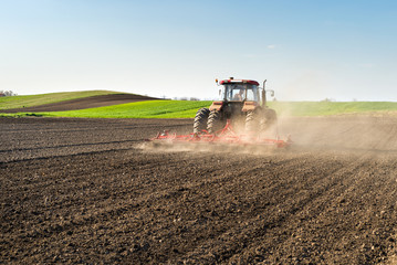 Tractor preparing land