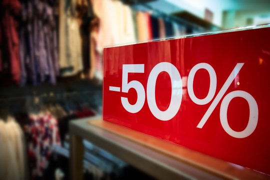 clothing store sales/clothing store discount sale with a fifty percent off price tag