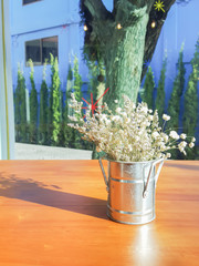 Bouquet of white gypsophila, baby's breath flowers, on wooden ta