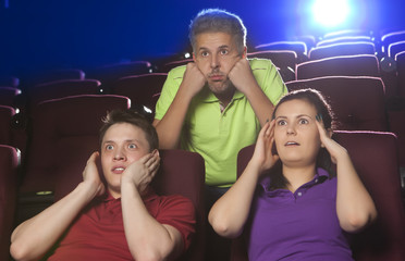 Naklejka premium People at the cinema watching an horror movie