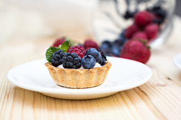 Tart  with Fresh berries - dessert on wooden table close up